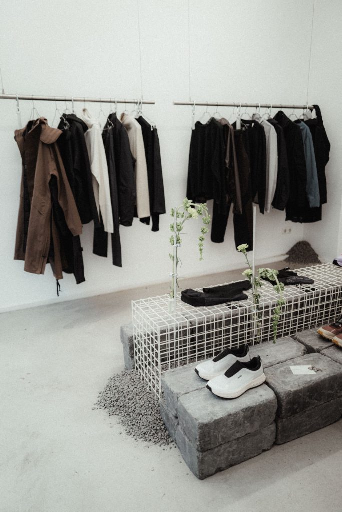 Functional fashion pieces on display in the Concrete to Gravel exhibition space, Munich 2025